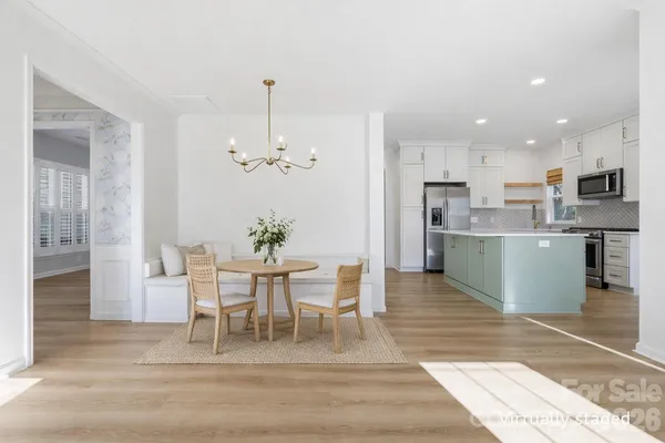 a view of kitchen with granite countertop cabinets and refrigerator