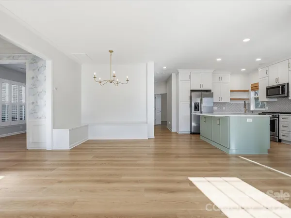 a view of a kitchen with a sink and a refrigerator