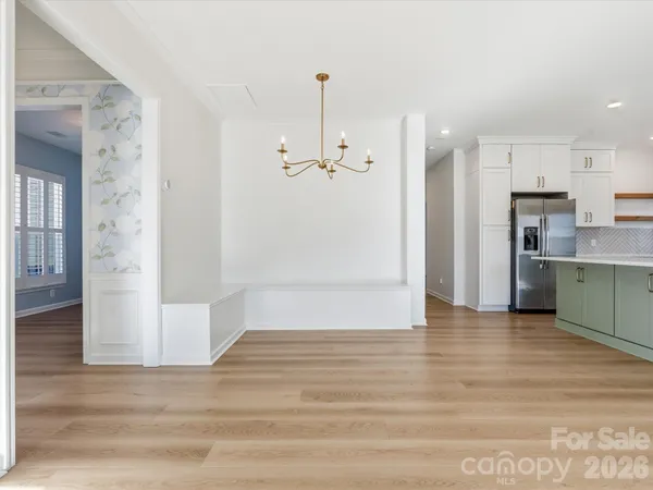 a view of a room with wooden floor and a bathroom