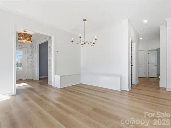 a kitchen with a refrigerator a stove top oven a sink and dishwasher with wooden floor