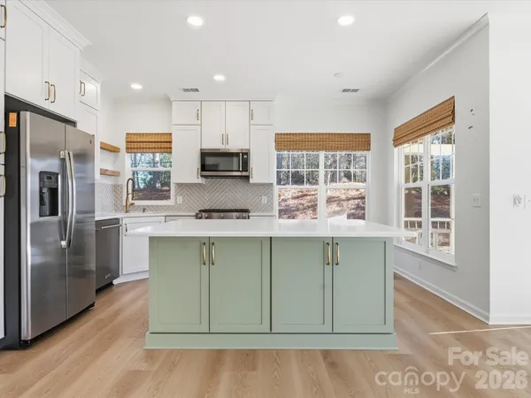 a kitchen with a stove a sink and a microwave
