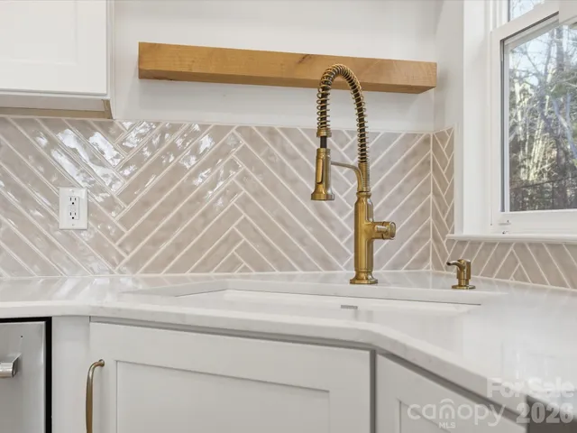 a kitchen with cabinets stainless steel appliances and a sink