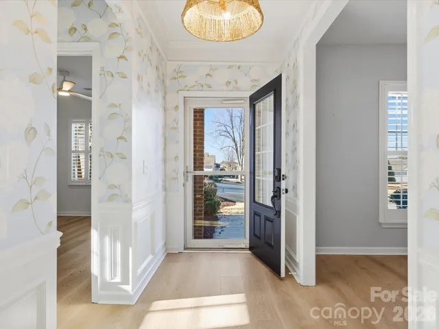 view of hall way with wooden floor and a bathroom