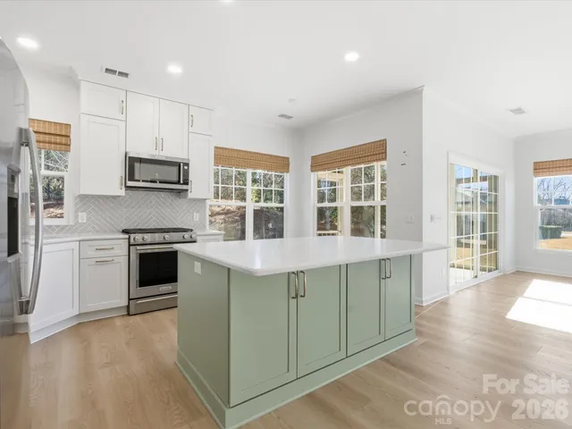 a view of a door and wooden floor in a room