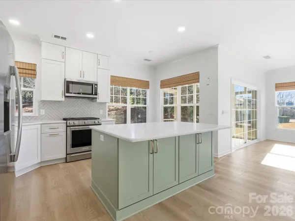 a view of a door and wooden floor in a room