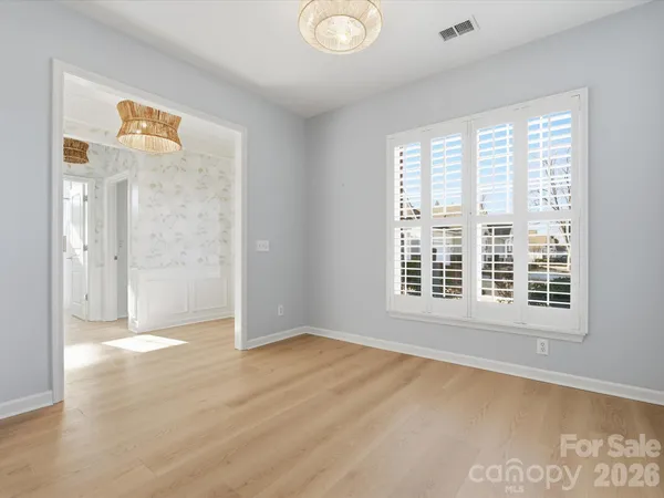 a view of a kitchen with wooden floor and a kitchen