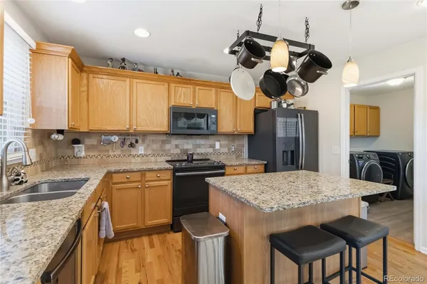 a kitchen with a stove a sink and a refrigerator