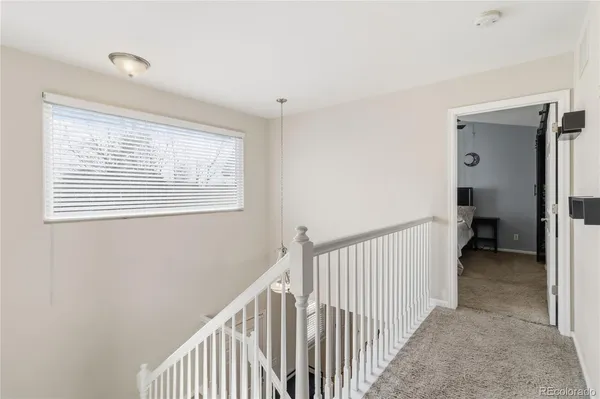 a view of a hallway with a window and a bedroom