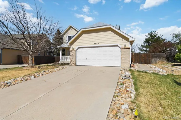 a view of garage and wooden fence
