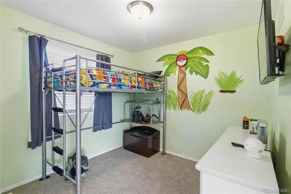 a bedroom with a bed and a desk