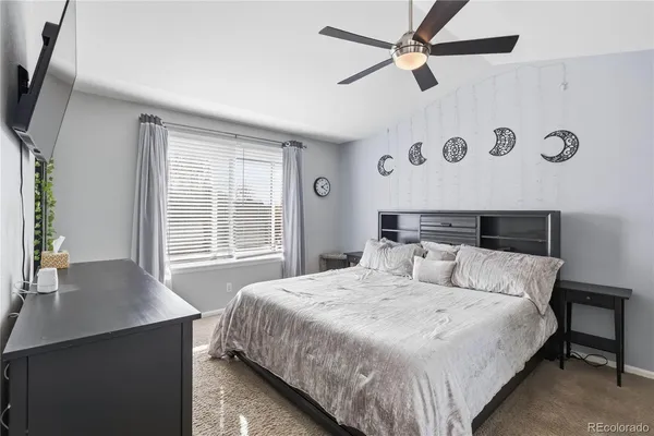 a bedroom with a large bed and a chandelier