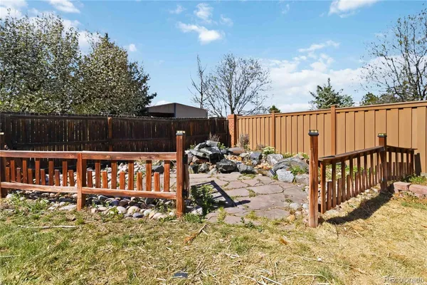 a view of a house with wooden fence