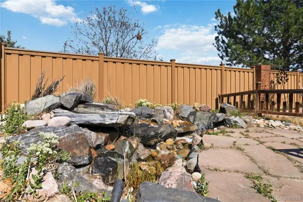 a view of a swimming pool with a patio and a garden