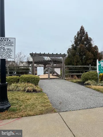 a view of a room with wooden floor and a window