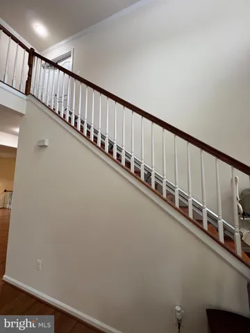 a view of kitchen with kitchen island microwave and wooden floor