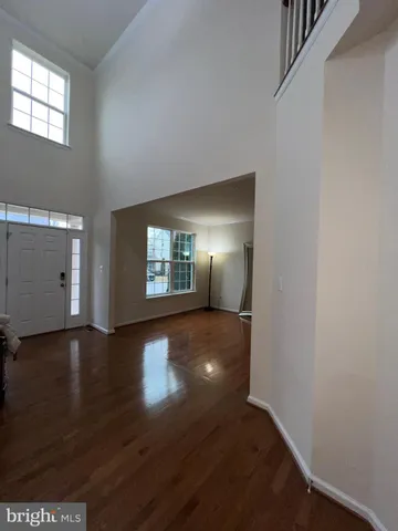 a living room with hard wood floors and a ceiling fan