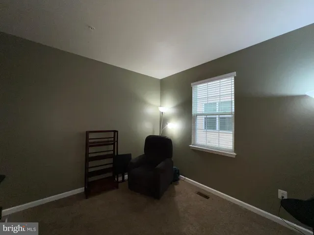 a spacious bathroom with a toilet sink and mirror