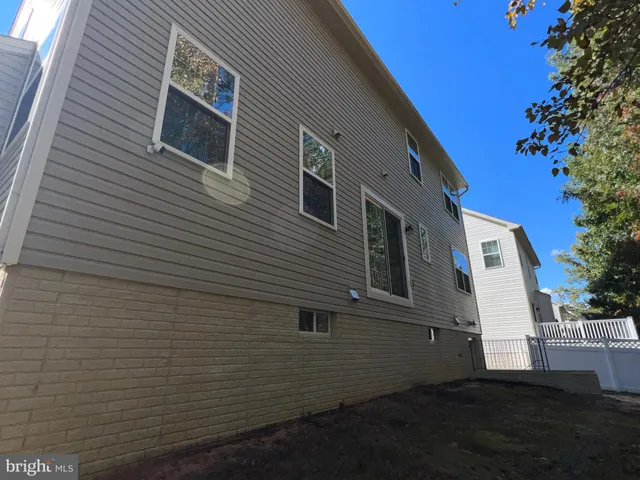 a view of an empty room with glass door and wooden floor