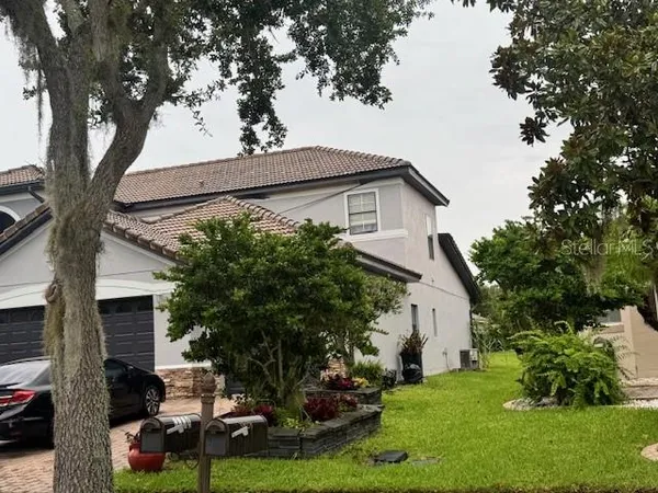 a view of backyard of house with green space