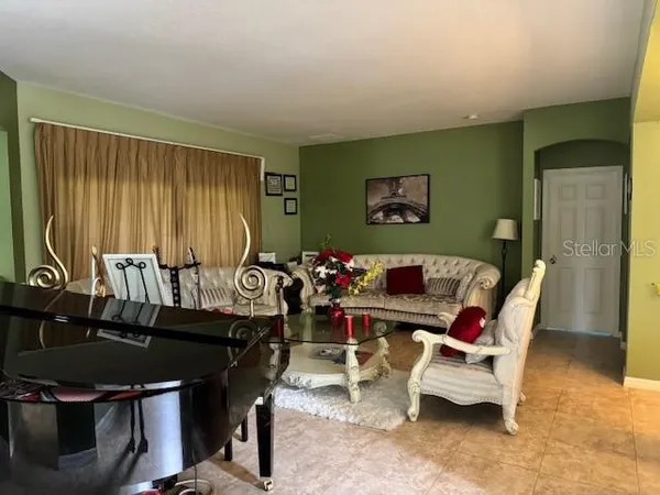 a living room with furniture a rug and a window
