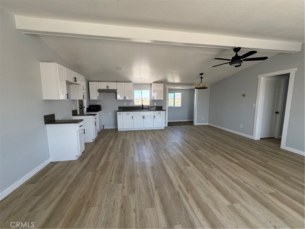 15030 Fairlane Road Lucerne Valley, CA 92356 - Photo 2 of 18 a large kitchen with cabinets wooden floor and stainless steel appliances