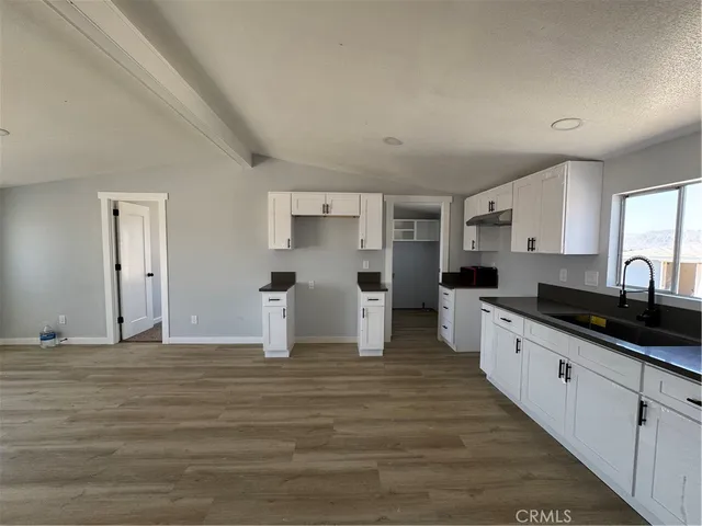 a large white kitchen with cabinets