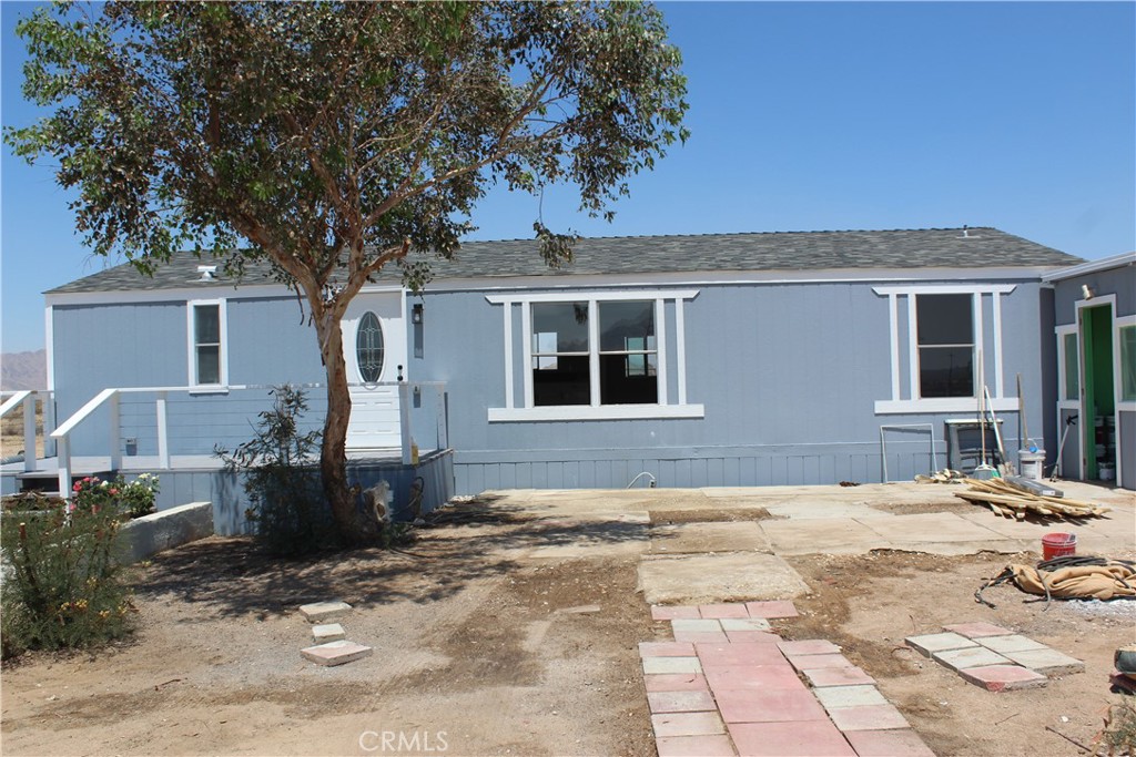 15030 Fairlane Road Lucerne Valley, CA 92356 - Photo 7 of 18 a front view of a house with a patio