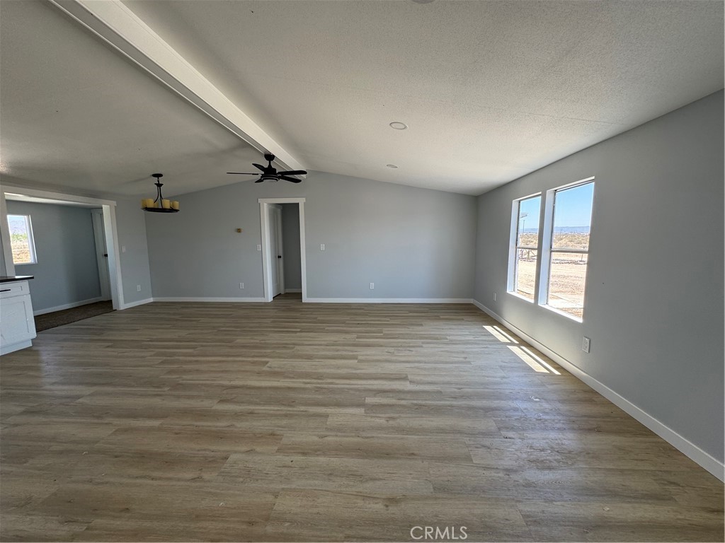 15030 Fairlane Road Lucerne Valley, CA 92356 - Photo 8 of 18 wooden floor in an empty room with a window