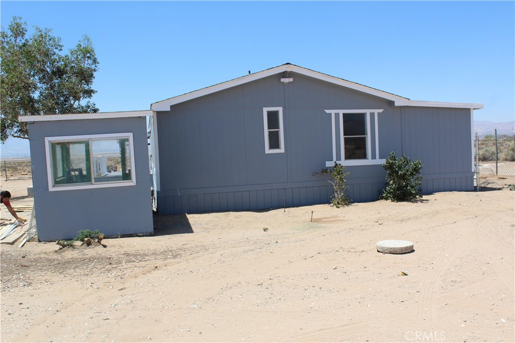 15030 Fairlane Road Lucerne Valley, CA 92356 - Photo 10 of 18 a front view of a house with a yard
