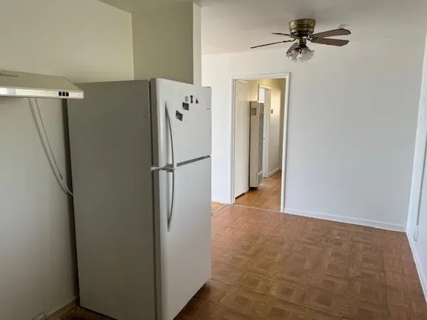 a view of a refrigerator in kitchen and a refrigerator in a kitchen
