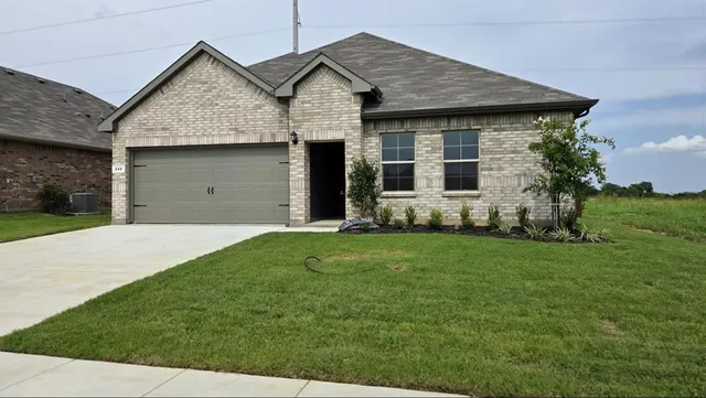 a front of a house with a garden
