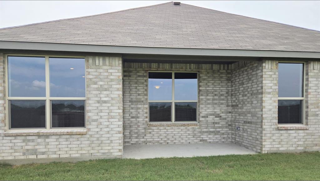 240 Kinley Street Grandview, TX 76050 - Photo 12 of 15 a front view of a house with garden