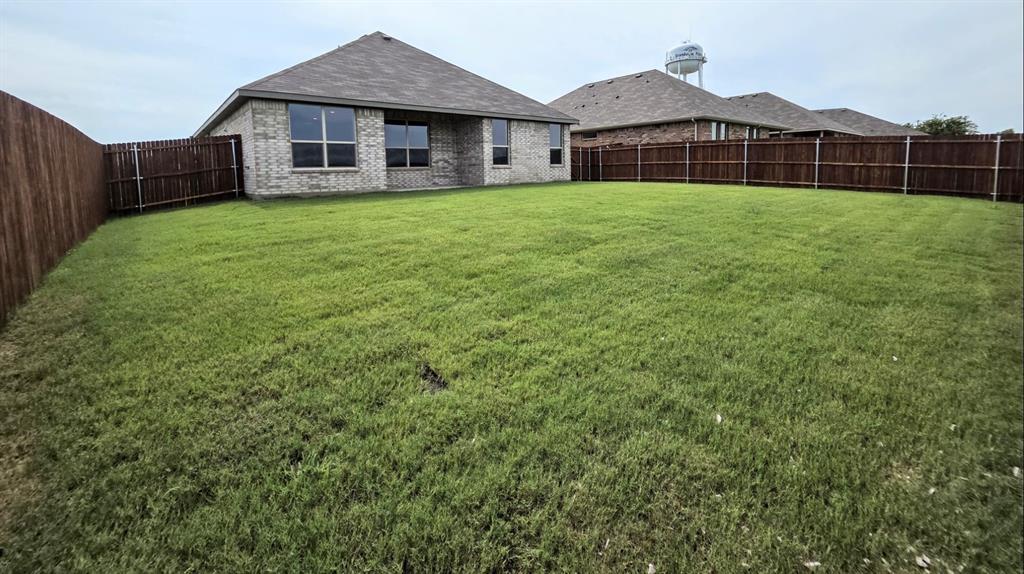 240 Kinley Street Grandview, TX 76050 - Photo 14 of 15 a front of a house with a garden