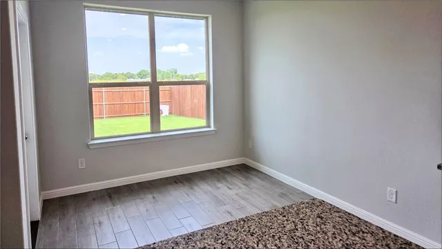 a kitchen with kitchen island granite countertop a sink a counter top space appliances and cabinets