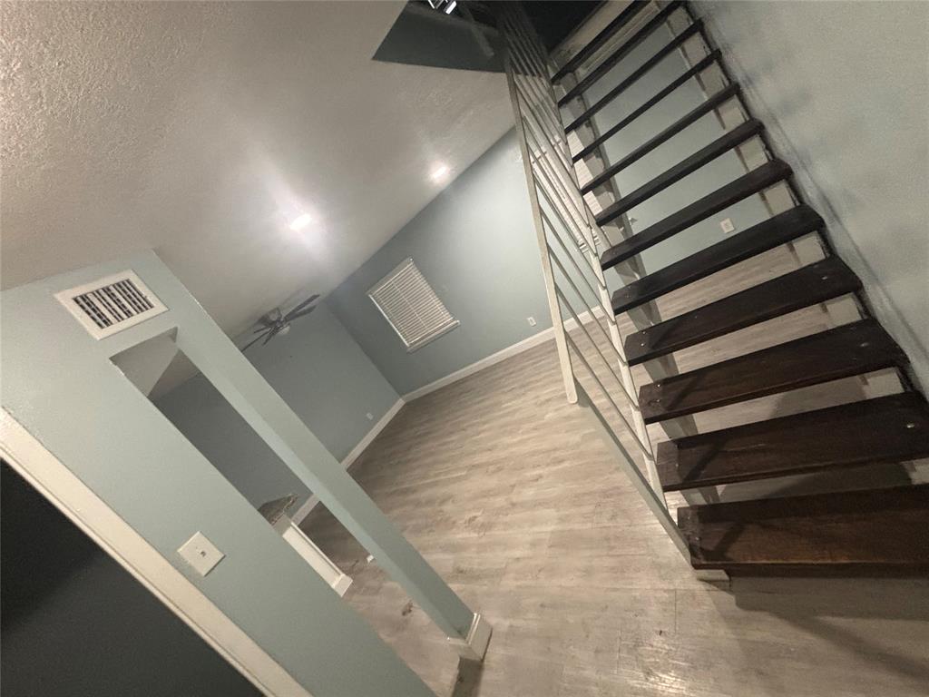 301 Rolston Road, Unit 305101 Irving, TX 75060 - Photo 2 of 7 Open-tread staircase with dark wood-finish treads and metal railing