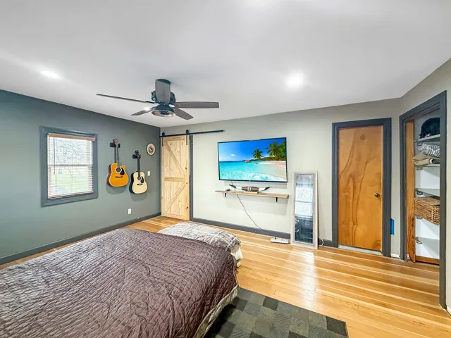 a bedroom with a bed and window