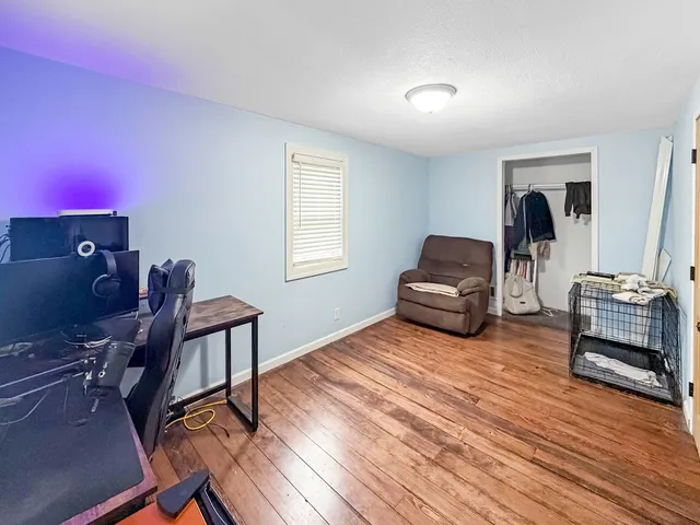 a view of a room with gym equipment and a window