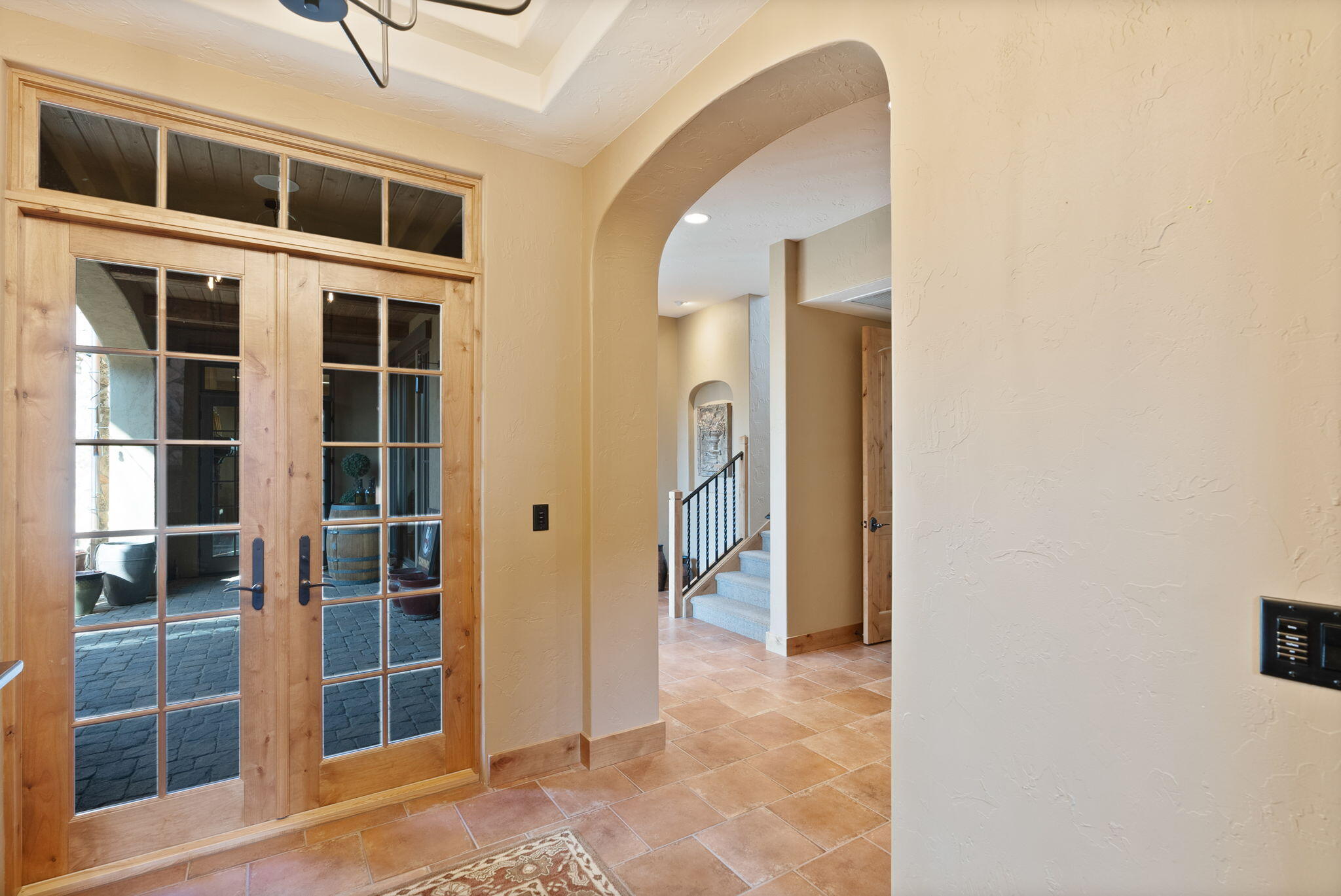 22887 Ghost Tree Lane Bend, OR 97701 - Photo 11 of 97 A grand foyer greets with recessed ceiling, updated chandelier and French doors opening to the courtyard