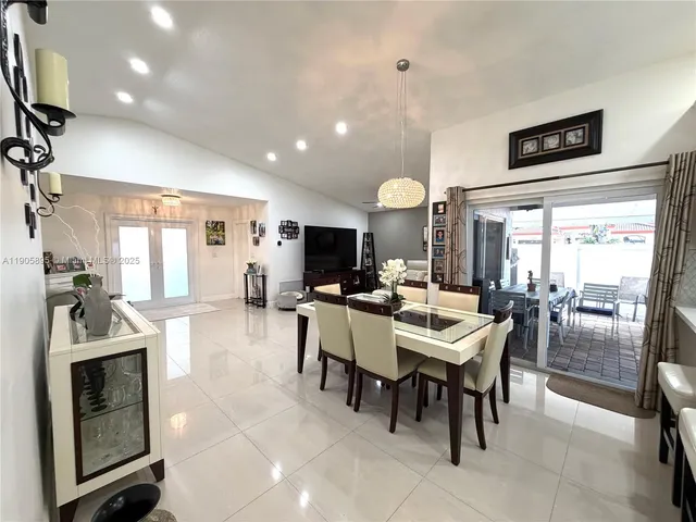 a kitchen with stainless steel appliances kitchen island granite countertop a refrigerator and a sink