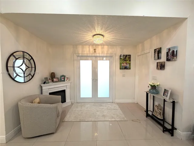 a kitchen with stainless steel appliances kitchen island a table chairs refrigerator and sink