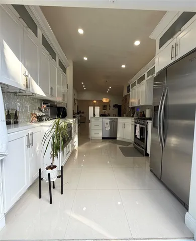 a bathroom with a sink a toilet a mirror and shower