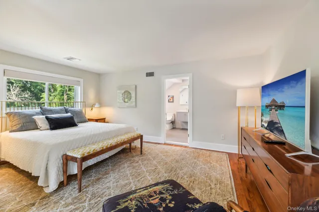 a bedroom with a bed and a desk