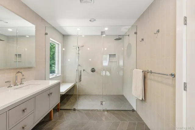 a spacious bathroom with a double vanity sink mirror and toilet