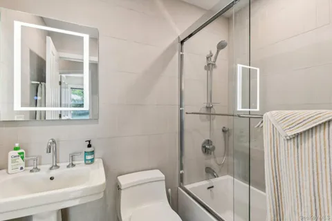 a bedroom with two beds and a large window