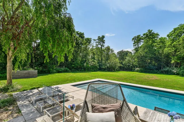 a view of a yard with a table and a chair