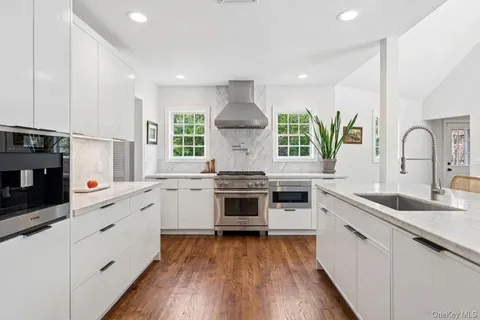 a kitchen with stainless steel appliances a stove sink and cabinets