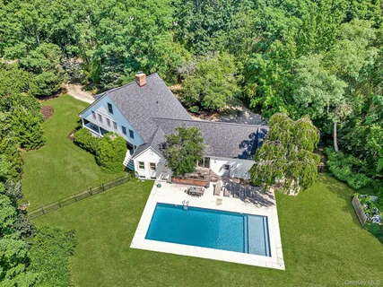 an aerial view of a house with yard swimming pool and outdoor seating