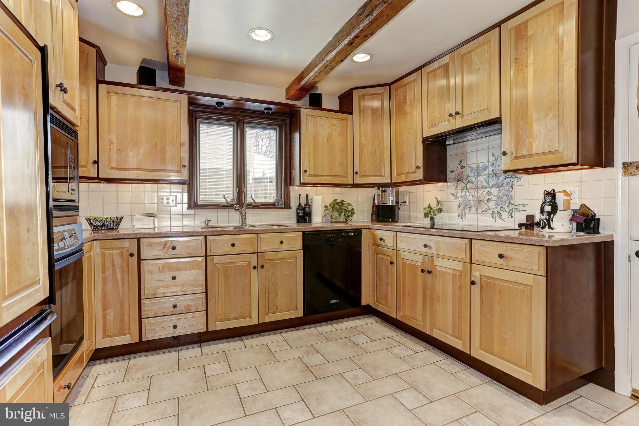 7918 Ruxway Road Baltimore, MD 21204 - Photo 7 of 30 Corian counters, ceramic flooring, beamed ceiling.