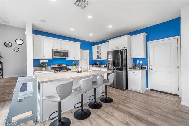 a kitchen with refrigerator and cabinets