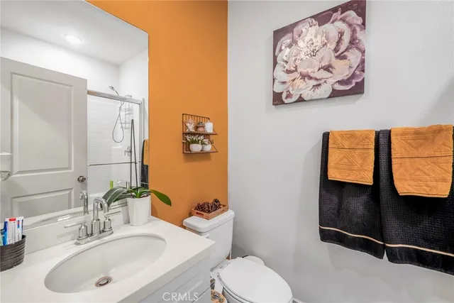 a bathroom with a sink mirror and toilet